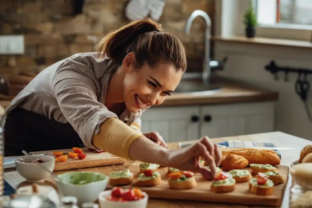 About Me 2 Chef Florence smiling while cooking in a bright modern kitchen