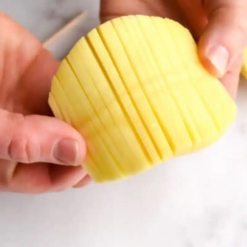 Accordion Potatoes Recipe – Crispy, Easy, and Absolutely Stunning 4 cut narrow lines into the potato, going perpendicular (opposite) to the skewers