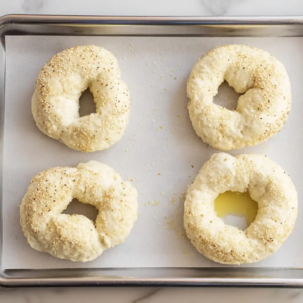 3 Ingredient Bagels: Easy, Protein-Rich, No Yeast Recipe 3 ingredient bagels unbaked 3 ingredient bagels on parchment paper