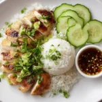 Steamed Chicken and Rice: Hainanese-Inspired One-Pot Comfort Meal Steamed Chicken And Rice Steamed chicken and rice served with scallions and sauce